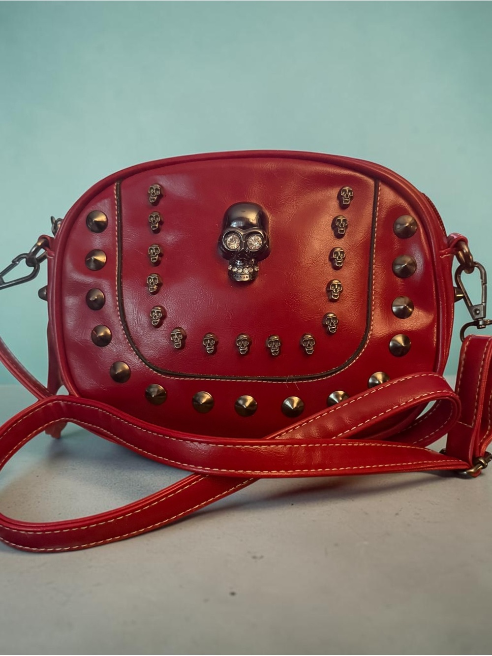 Red skulls and studs faux leather crossbody bag